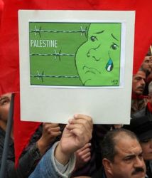 A protester holds a poster during a protest held by Arab Communists activists to show solidarity with the Palestinians in the Gaza Strip, at Arnous square in Damascus January 16, 2009. REUTERS/Khaled al-Hariri  (SYRIA)