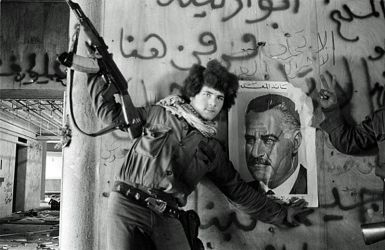 (FILES) -- A pro-Palestinian fighter sticks 24 March 1976 a portrait of Egyptian President Nasser on the wall of the destroyed Holiday Inn hotel in central Beirut  after pro-Palestinian militias dislodged 21 March the Lebanese Christian forces from the twenty seven storey hotel. Lebanon, mired in political crisis and hit by a series of bomb attacks, is to mark 13 April 2005 the 30th anniversary of the start of its devastating civil war with a cultural and sporting festival under the slogan of "unity". AFP PHOTO/XAVIER BARON
(Photo credit should read XAVIER BARON/AFP/Getty Images)